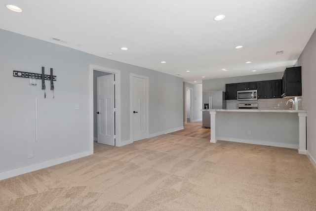 unfurnished living room featuring recessed lighting, visible vents, baseboards, and light colored carpet