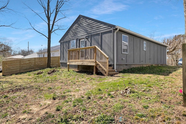 back of property featuring fence and board and batten siding