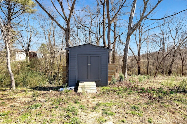 view of shed with a forest view