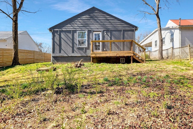 rear view of property with a sunroom and fence