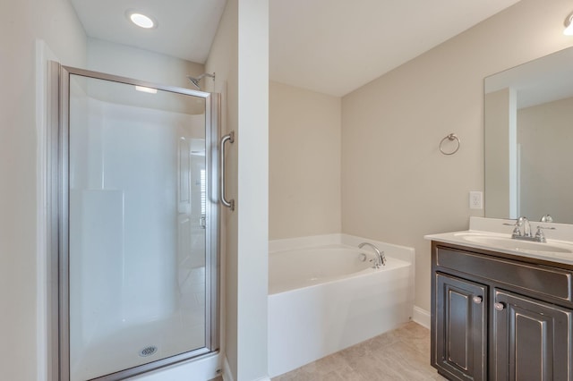 full bathroom featuring a shower stall, vanity, and a bath