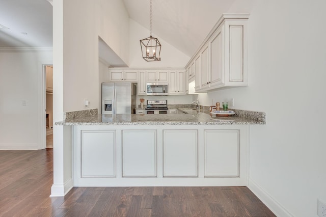 kitchen with a peninsula, light stone countertops, appliances with stainless steel finishes, and a sink