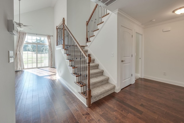 stairway featuring high vaulted ceiling, wood finished floors, a ceiling fan, baseboards, and ornamental molding