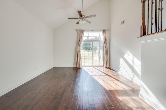 interior space with dark wood finished floors, visible vents, a ceiling fan, high vaulted ceiling, and baseboards