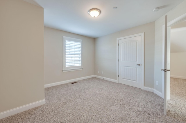 unfurnished bedroom featuring carpet floors, visible vents, and baseboards