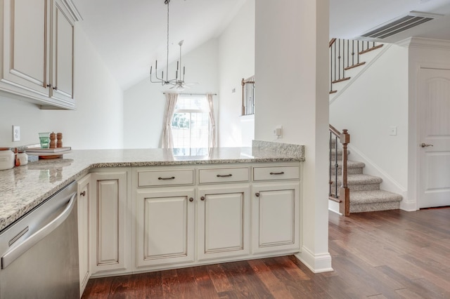 kitchen featuring light stone counters, visible vents, dark wood finished floors, and stainless steel dishwasher