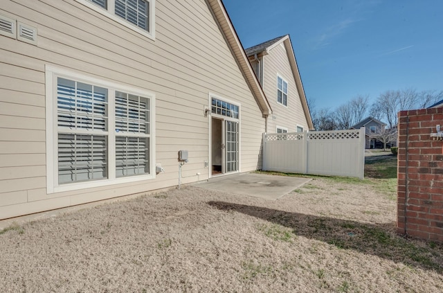 back of property featuring a patio area and fence