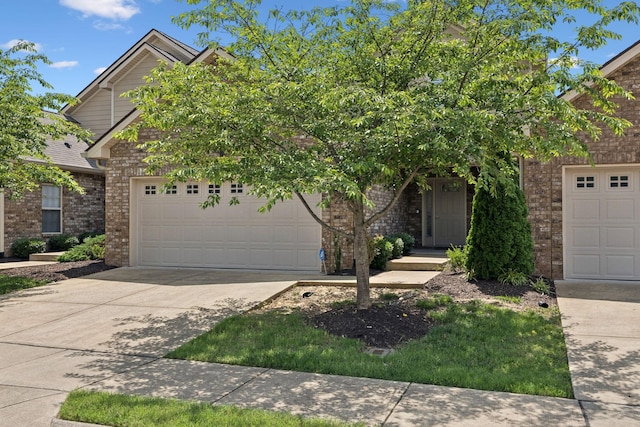 1012 Irish Way, Spring Hill, TN 37174 - view of property hidden behind natural elements with brick siding, concrete driveway, and an attached garage