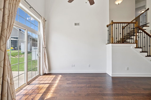 1012 Irish Way, Spring Hill, TN 37174 - empty room with hardwood / wood-style floors, ceiling fan, baseboards, stairway, and a towering ceiling