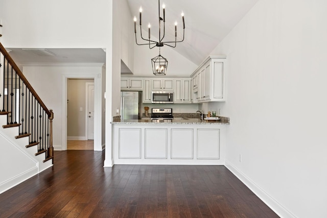 1012 Irish Way, Spring Hill, TN 37174 - kitchen with stainless steel appliances, a chandelier, dark wood finished floors, baseboards, and light stone countertops