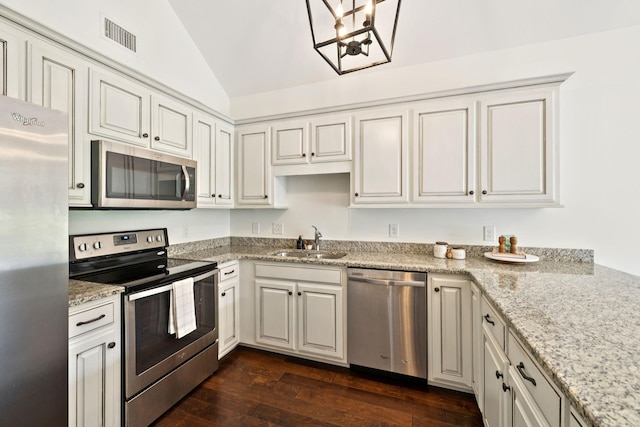 1012 Irish Way, Spring Hill, TN 37174 - kitchen with stainless steel appliances, a sink, lofted ceiling, dark wood-style floors, and light stone counters