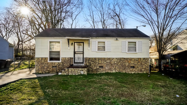 view of front of house with stone siding, crawl space, and a front yard