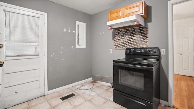 kitchen with visible vents, baseboards, decorative backsplash, black electric range, and under cabinet range hood