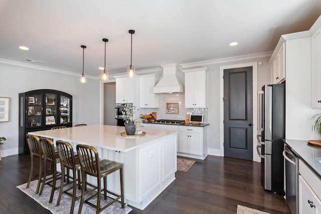 kitchen featuring stainless steel appliances, a center island, dark wood-style flooring, and custom range hood