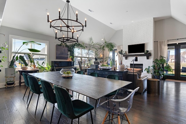 dining room with dark wood-type flooring, visible vents, plenty of natural light, and a fireplace