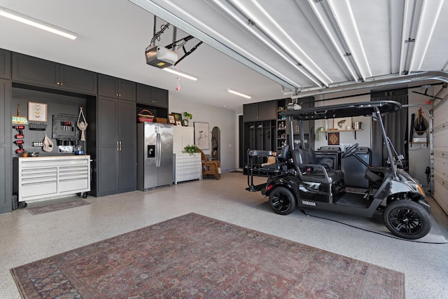 garage featuring a garage door opener and stainless steel fridge with ice dispenser