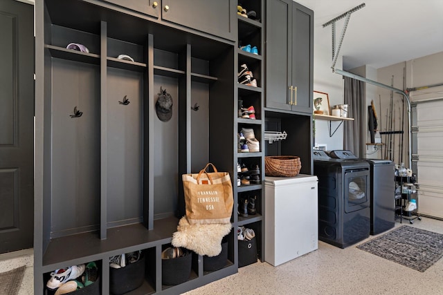 interior space featuring a garage, cabinet space, and washer and clothes dryer