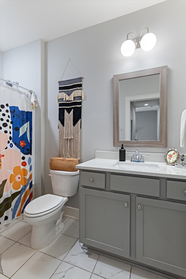 bathroom featuring toilet, marble finish floor, curtained shower, and vanity