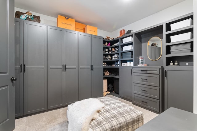 walk in closet featuring light carpet