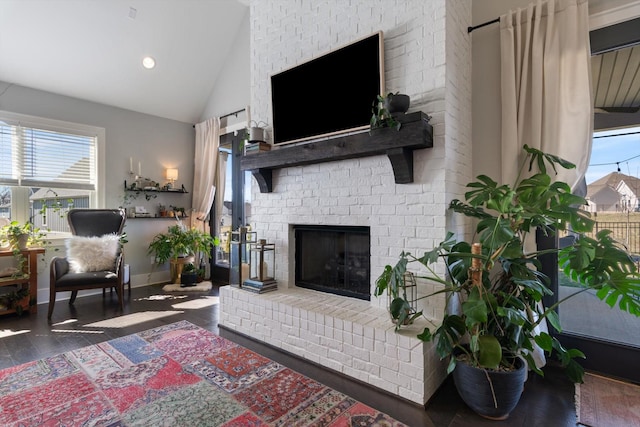 living room featuring recessed lighting, a brick fireplace, wood finished floors, high vaulted ceiling, and baseboards