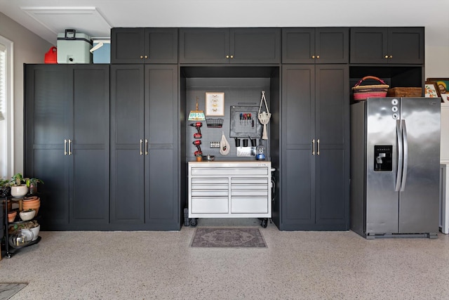 kitchen with stainless steel fridge and light speckled floor