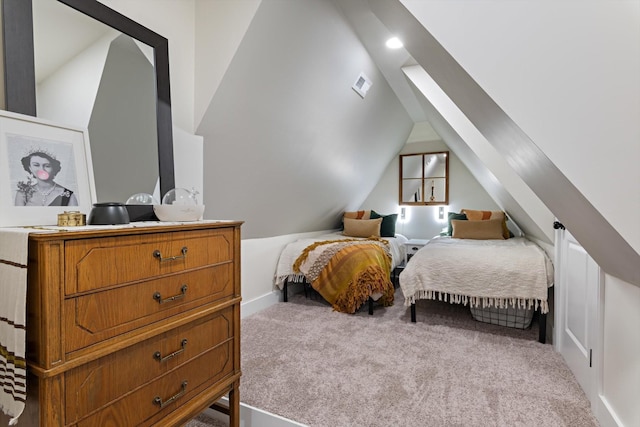 carpeted bedroom with vaulted ceiling and visible vents