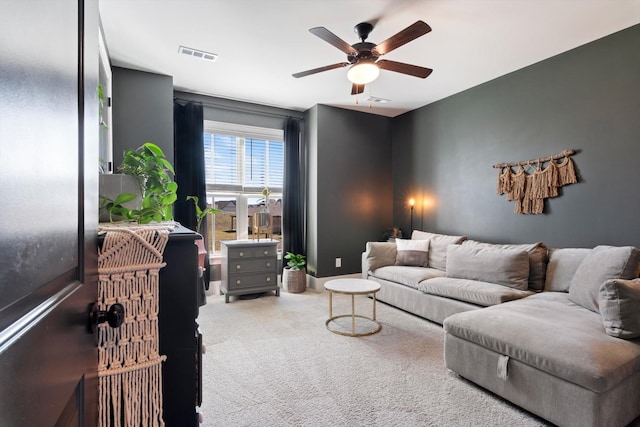 carpeted living room featuring visible vents and ceiling fan