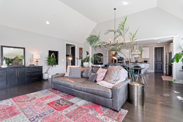 living area featuring an inviting chandelier, high vaulted ceiling, dark wood finished floors, and recessed lighting