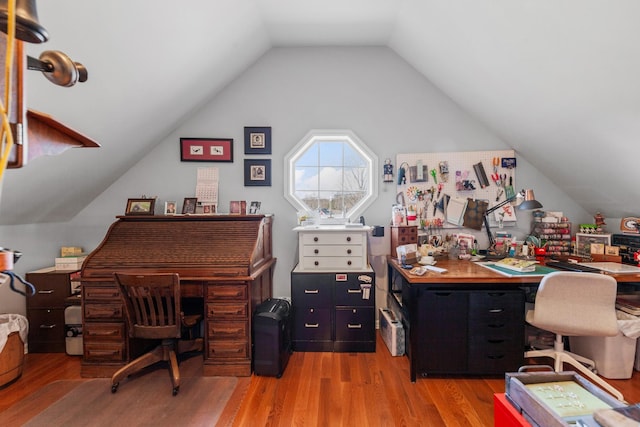 office with vaulted ceiling and light wood-type flooring