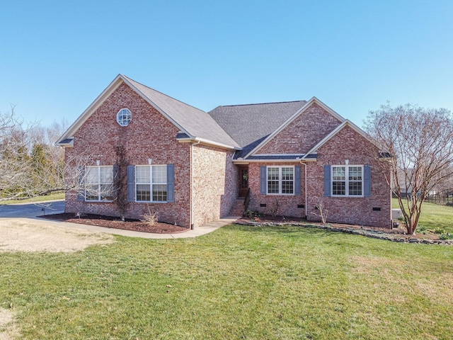 view of front of property with crawl space, brick siding, and a front yard