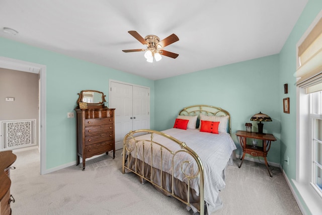 carpeted bedroom with ceiling fan, a closet, visible vents, and baseboards