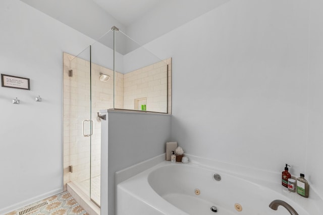 bathroom featuring a stall shower, visible vents, and a whirlpool tub