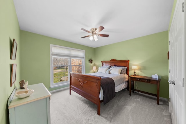 carpeted bedroom with a ceiling fan and baseboards