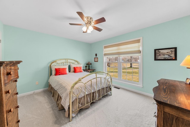 carpeted bedroom with visible vents, ceiling fan, and baseboards