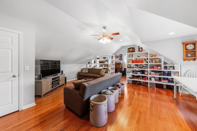 living area featuring lofted ceiling, ceiling fan, light wood-style flooring, and baseboards