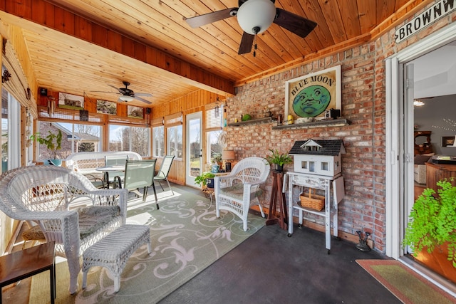 sunroom featuring wooden ceiling and a ceiling fan