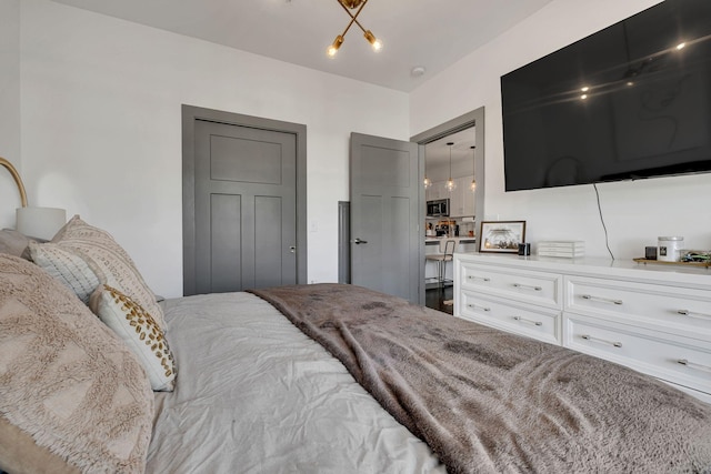 bedroom featuring a notable chandelier