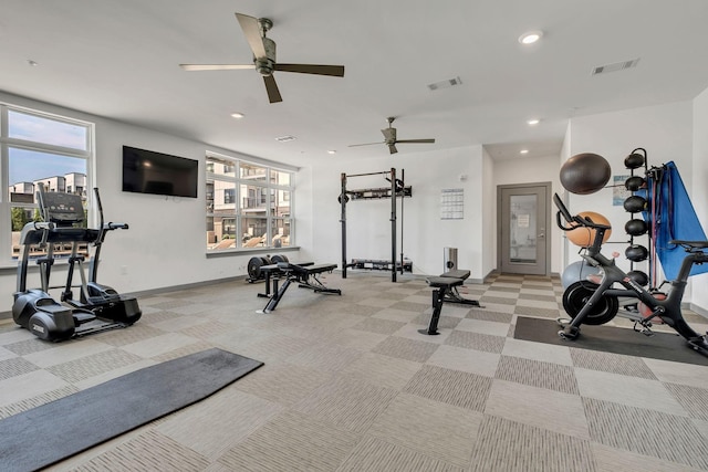 gym with light colored carpet, a healthy amount of sunlight, and visible vents