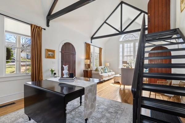 office area featuring high vaulted ceiling, beam ceiling, visible vents, and wood finished floors