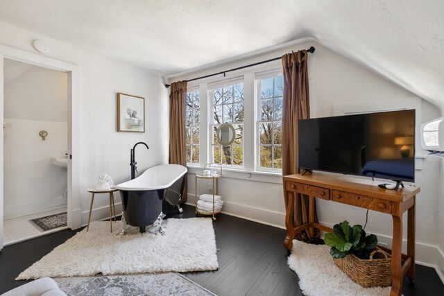 home office featuring lofted ceiling, wood-type flooring, and baseboards