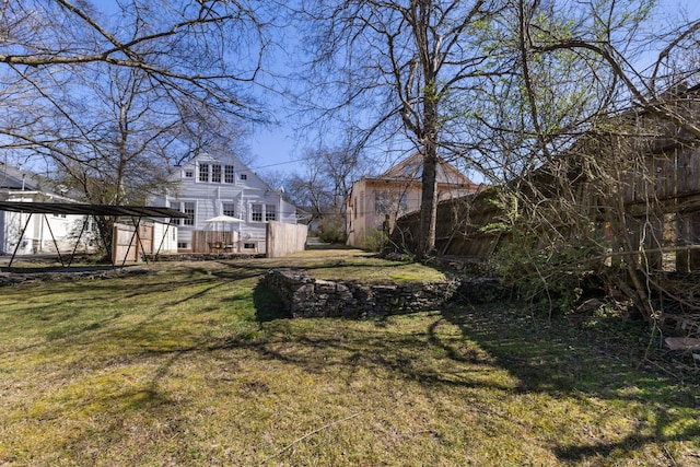 view of yard featuring a carport and a deck