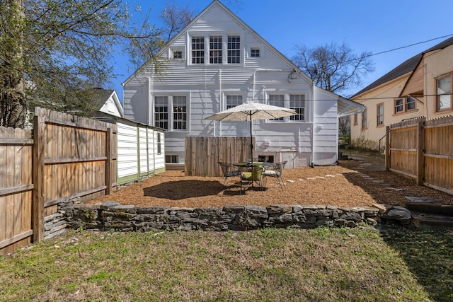 rear view of property featuring fence