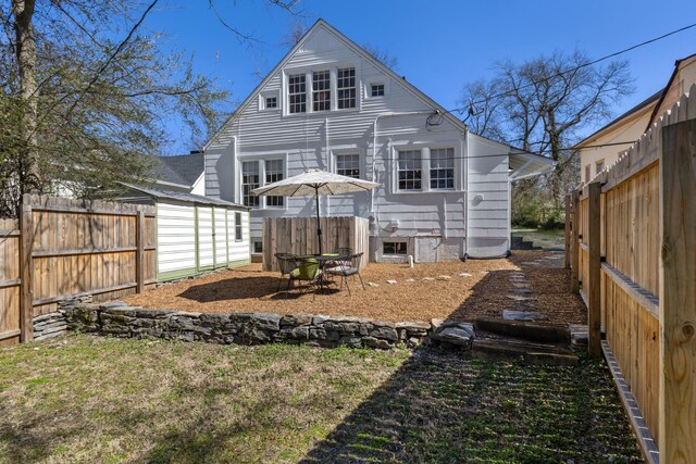 rear view of property with fence