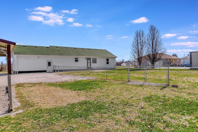 back of house featuring a yard and fence