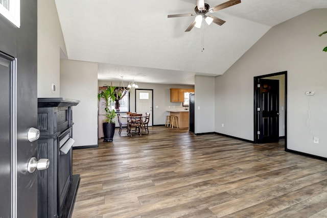 living room with ceiling fan, baseboards, and wood finished floors