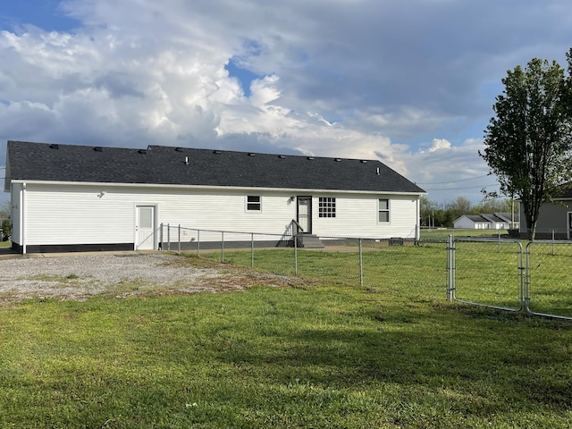 107 Sandy Rd, Unionville, TN 37180 - back of house featuring a gate, fence, a shingled roof, and a lawn