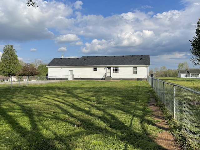 107 Sandy Rd, Unionville, TN 37180 - back of property with entry steps, a fenced backyard, and a lawn