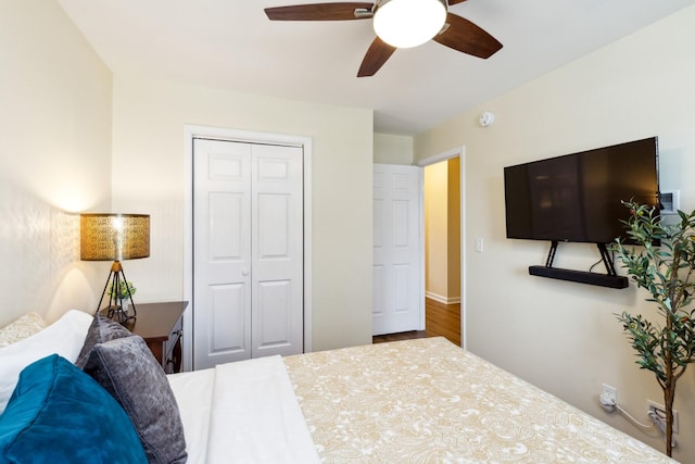 bedroom with ceiling fan, a closet, and wood finished floors