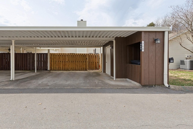 covered parking lot featuring fence