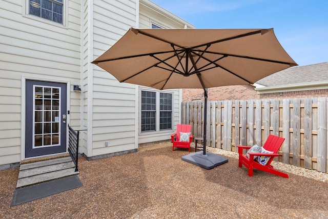 view of patio / terrace featuring entry steps and fence